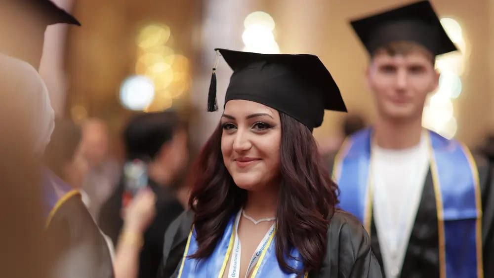 A graduate in cap and gown at the ceremony