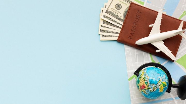 Travel essentials — passport, plane, globe and map laid out for a study-abroad journey
